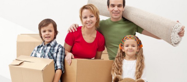 Family-with-children-moving-house-with-boxes-and-a-teddy